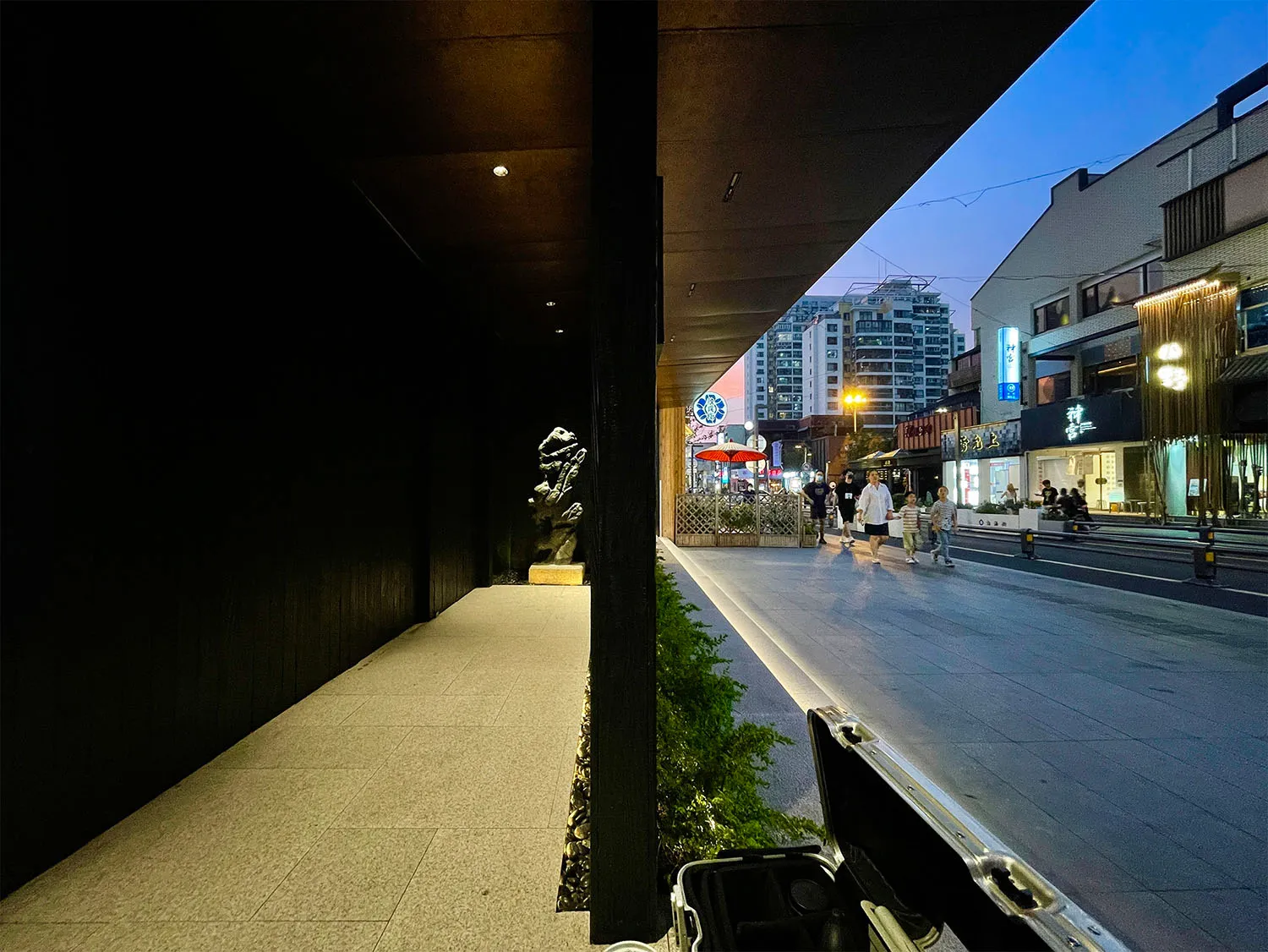 A bustling urban streetscape featuring concrete sidewalks and asphalt roads.