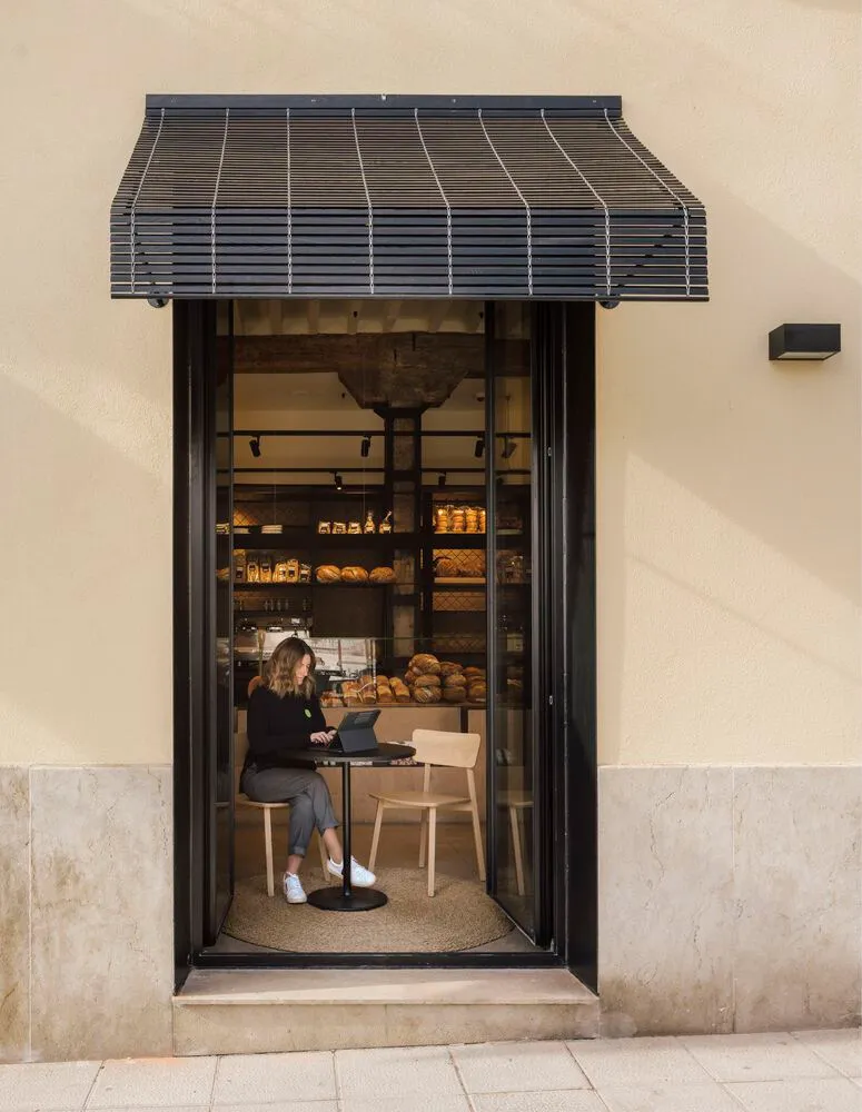 Modern cafe interior with glass facade and wood elements