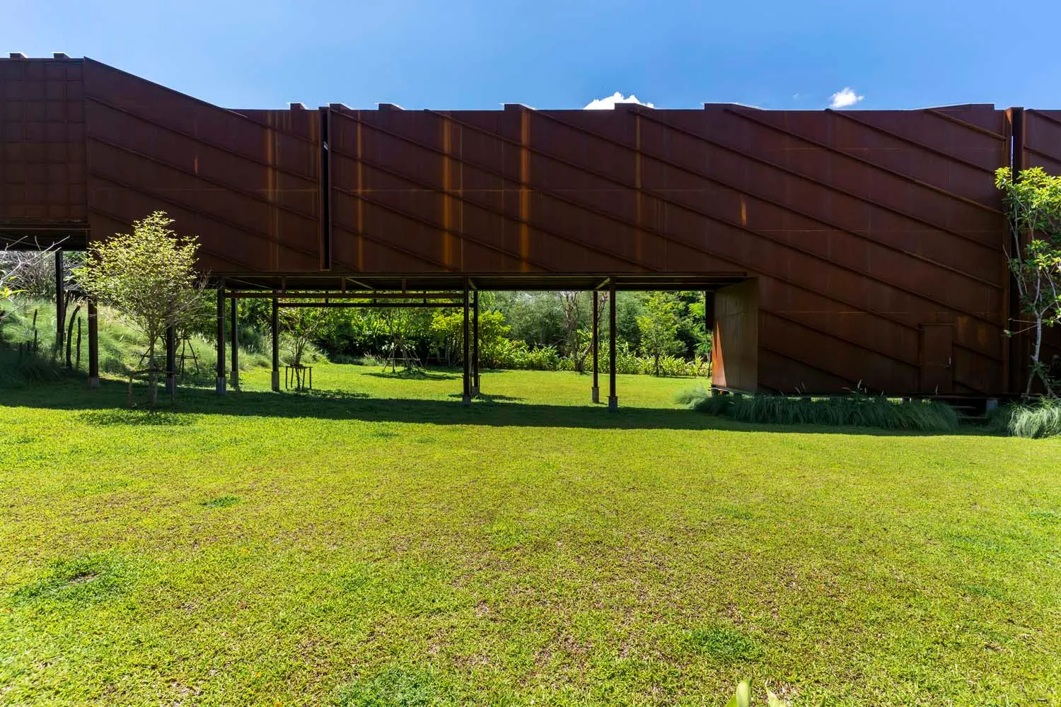 Modern, architectural design featuring a flat, rusted metal roof.