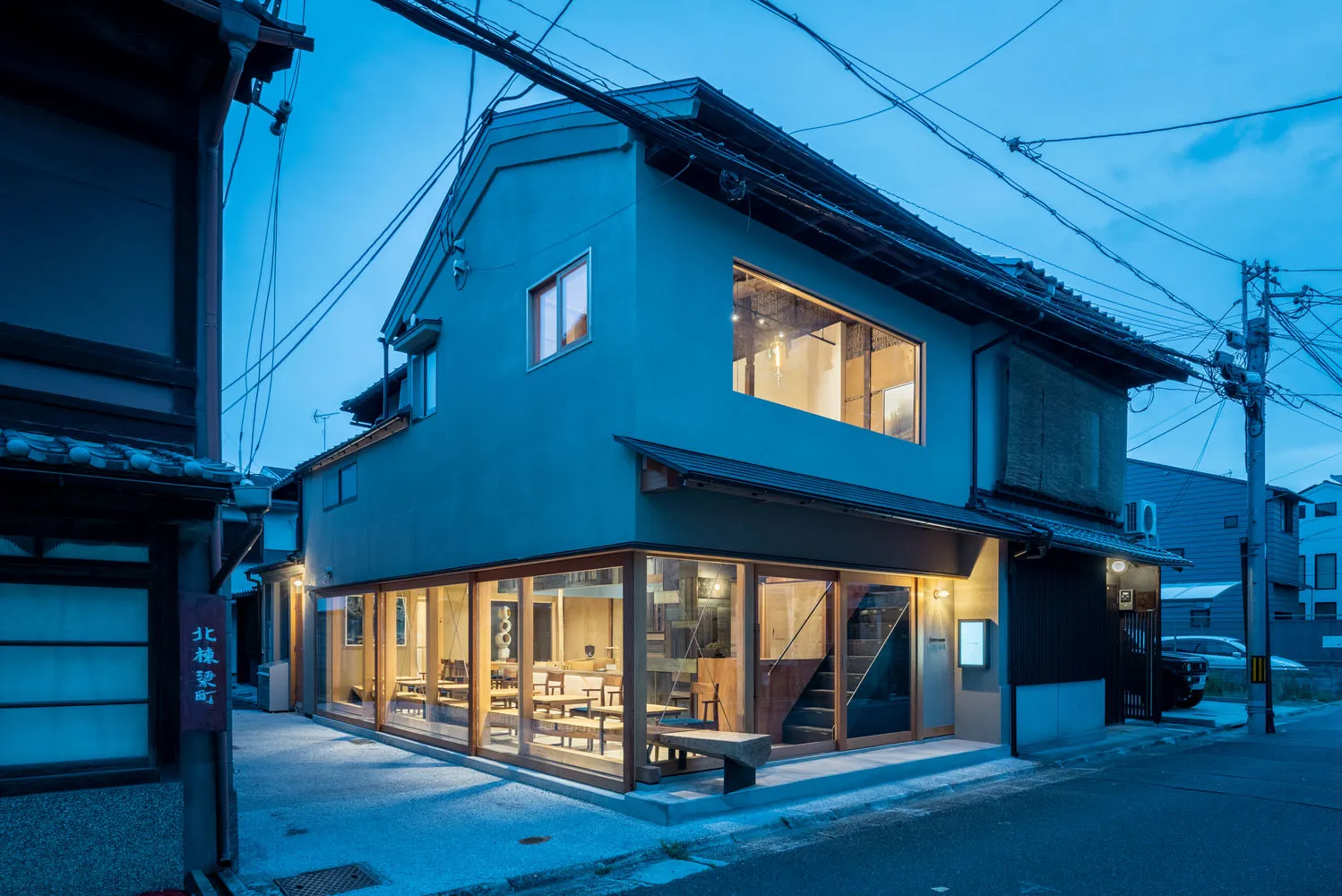 Modern storefront with glass windows and a cement exterior.