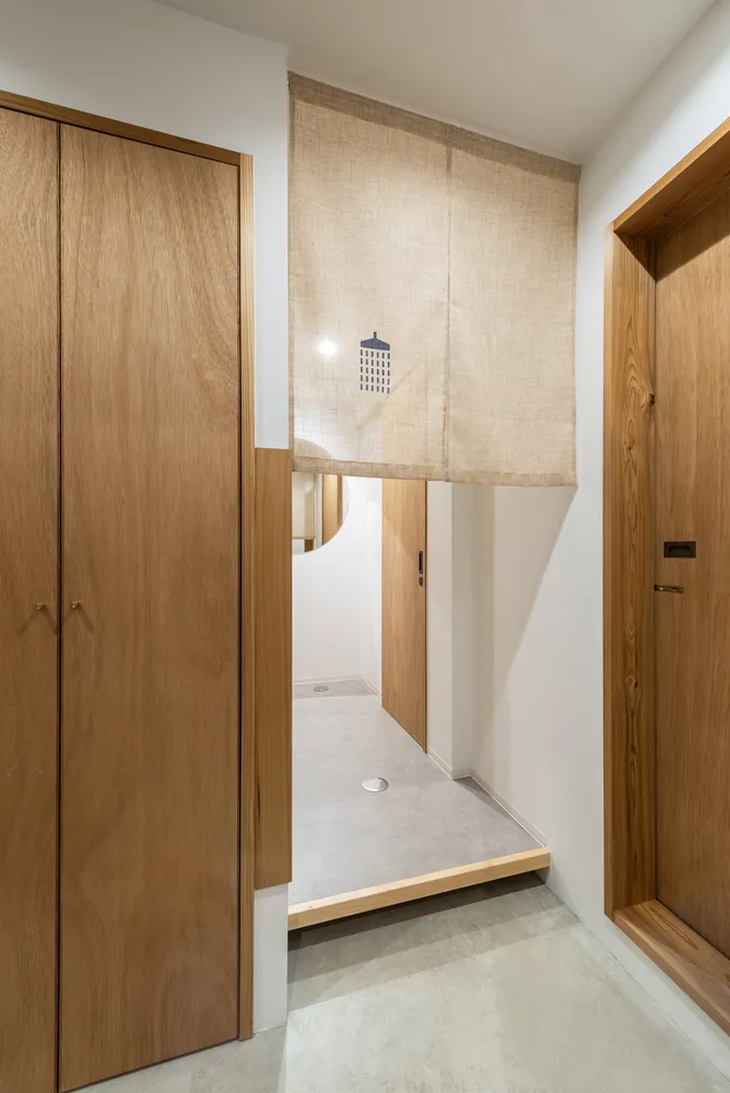 A wooden entry way with a minimalist design and a metallic gray floor.