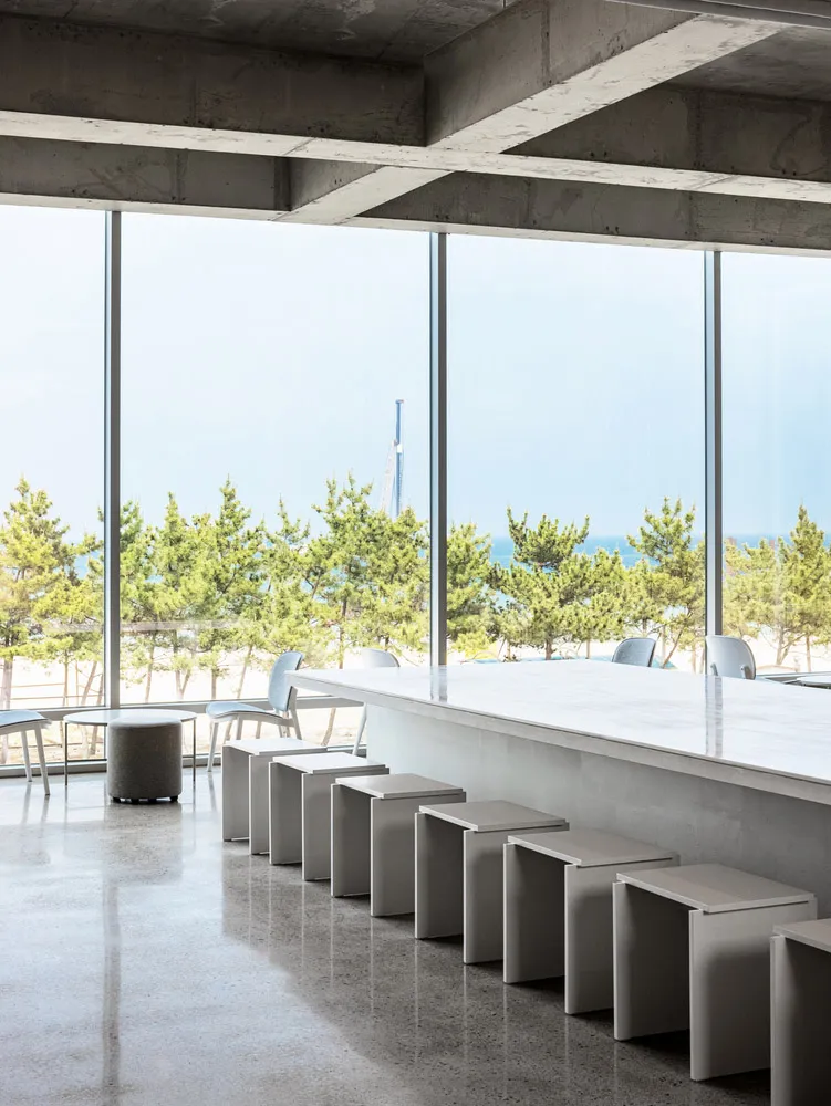 Industrial interior with concrete floors and stools.