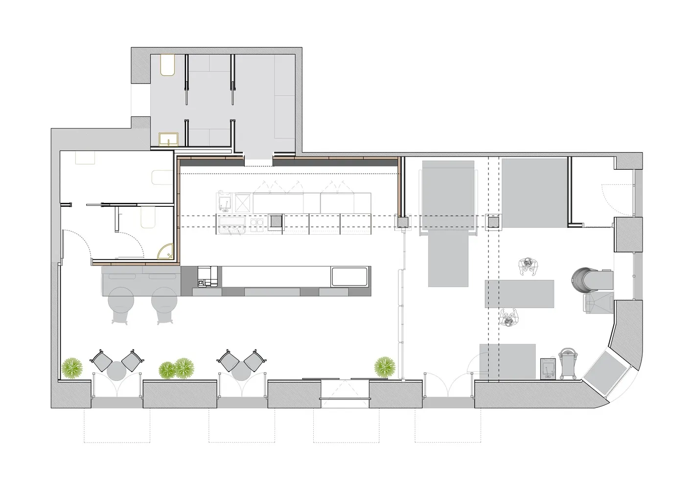 An industrial office space with workstations and a kitchen area.