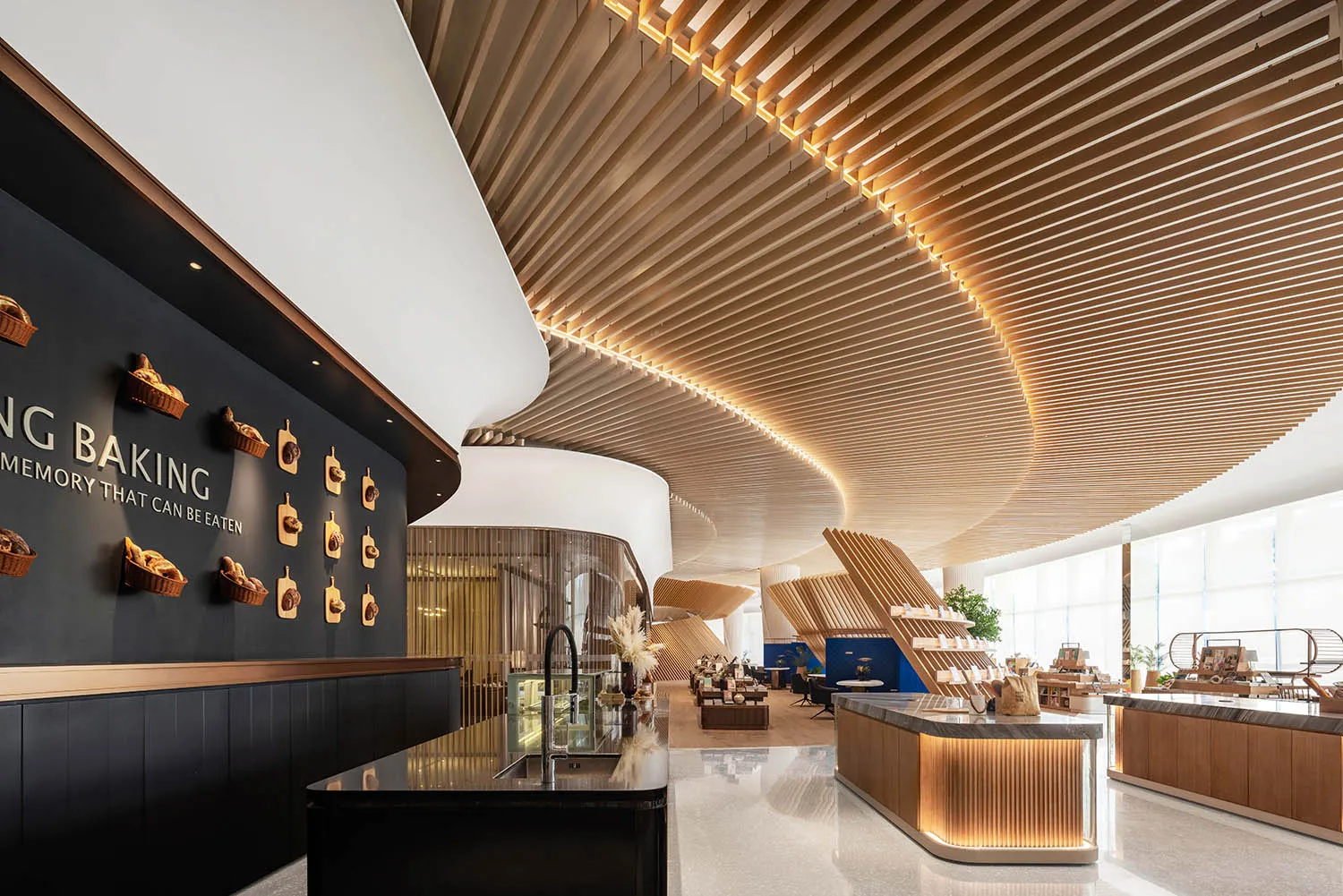A modern bakery interior with wooden materials, featuring a sleek kitchen counter and an elegant black and gold color scheme.