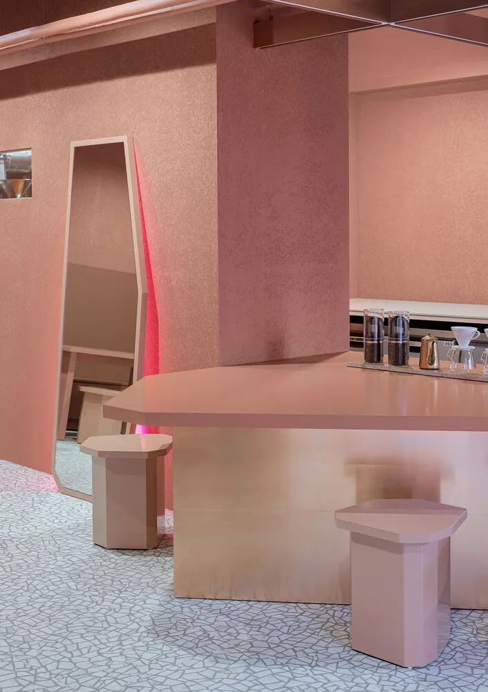 A modern, sleek coffee shop interior with light pink and white polypropylene materials.