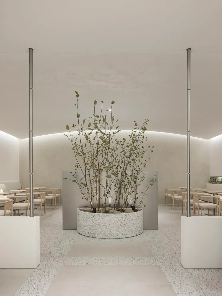 Interior of a modern restaurant featuring minimalist design and concrete surfaces.