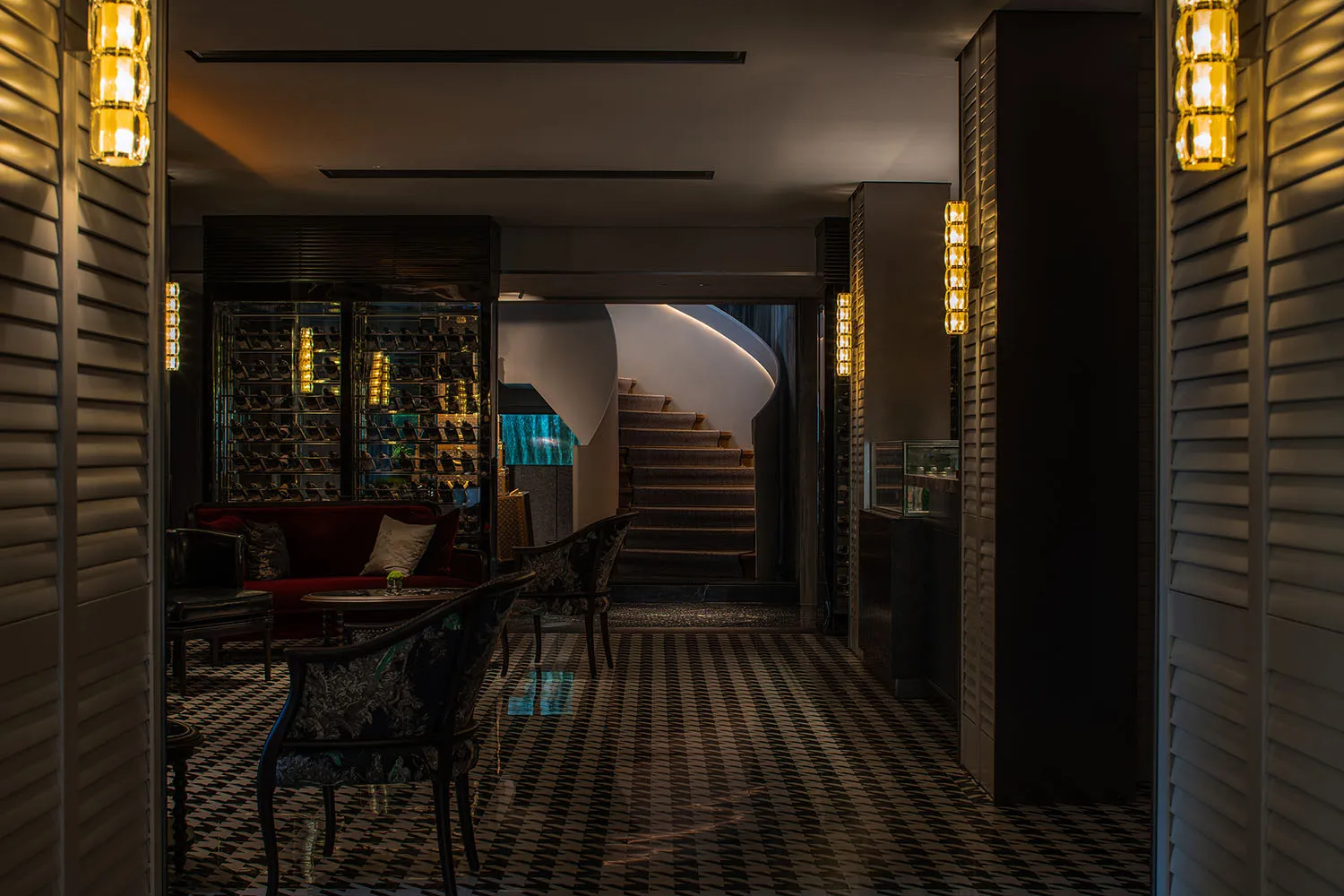 Modern hotel lobby featuring glass, wood, and metal materials