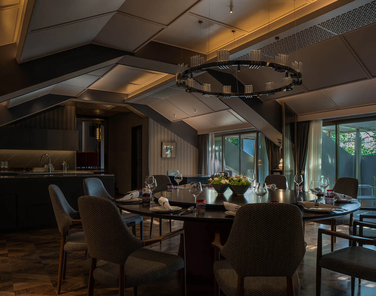Modern dining room with wooden table, leather chairs, and metal accents.