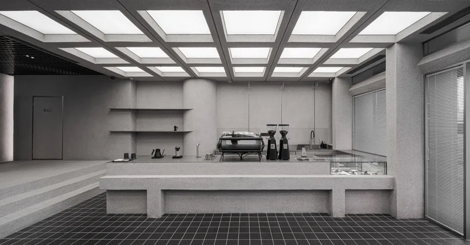 A minimalist coffee shop counter made of granite.
