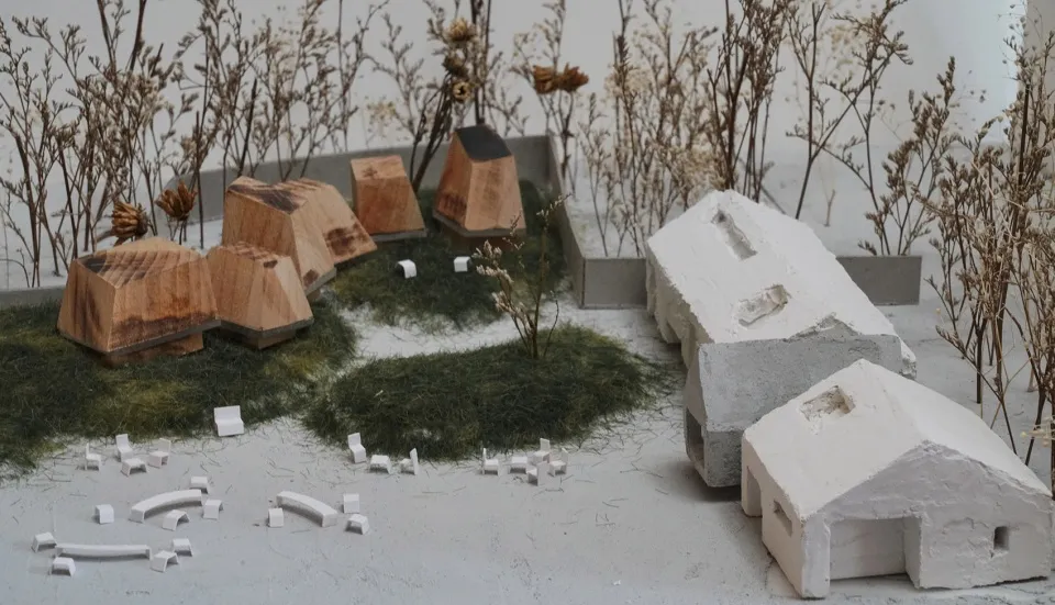 A modern architectural model featuring concrete and wooden structures.