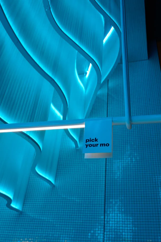 Modern interior with curved glass paneling and blue lighting