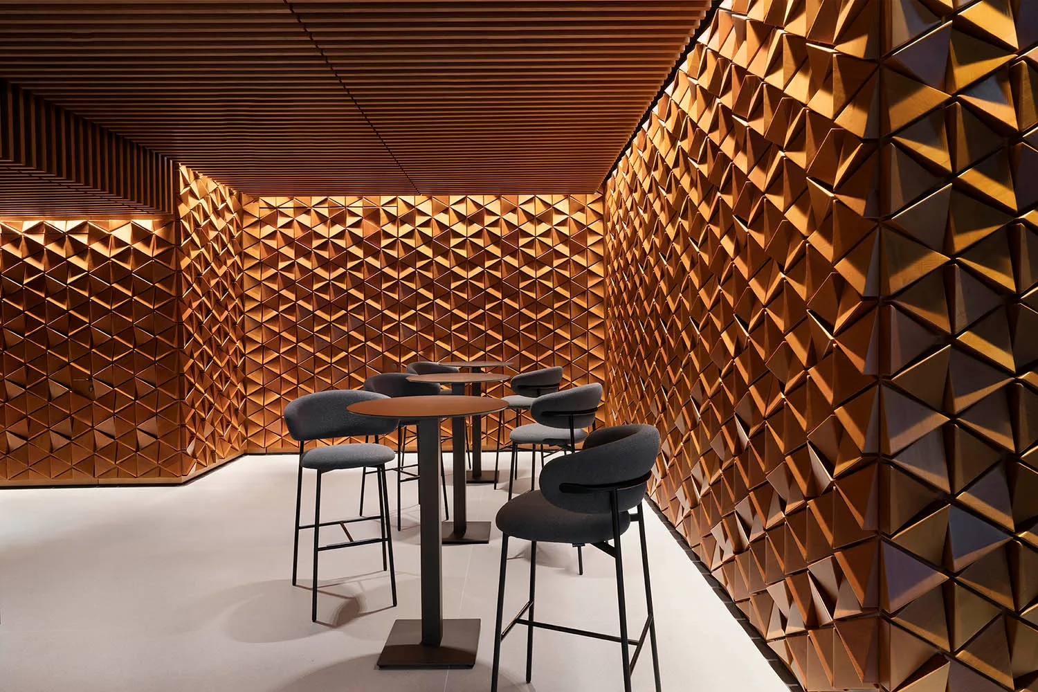 Modern restaurant interior with wooden decor and high-top seating