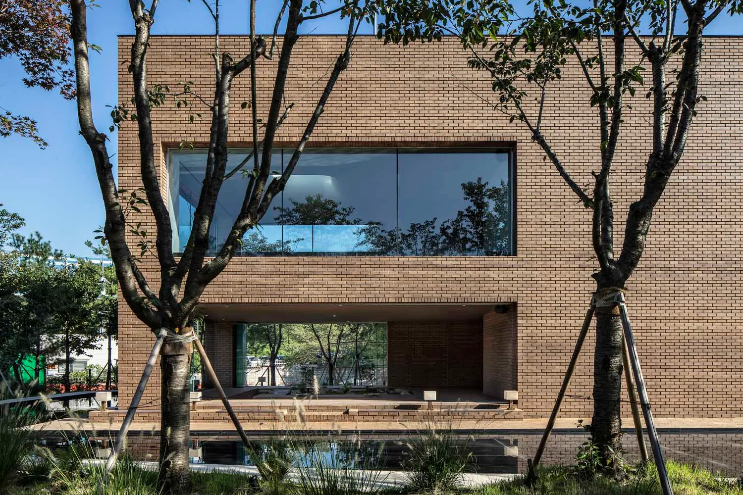 Modern house with brick exterior and large windows.