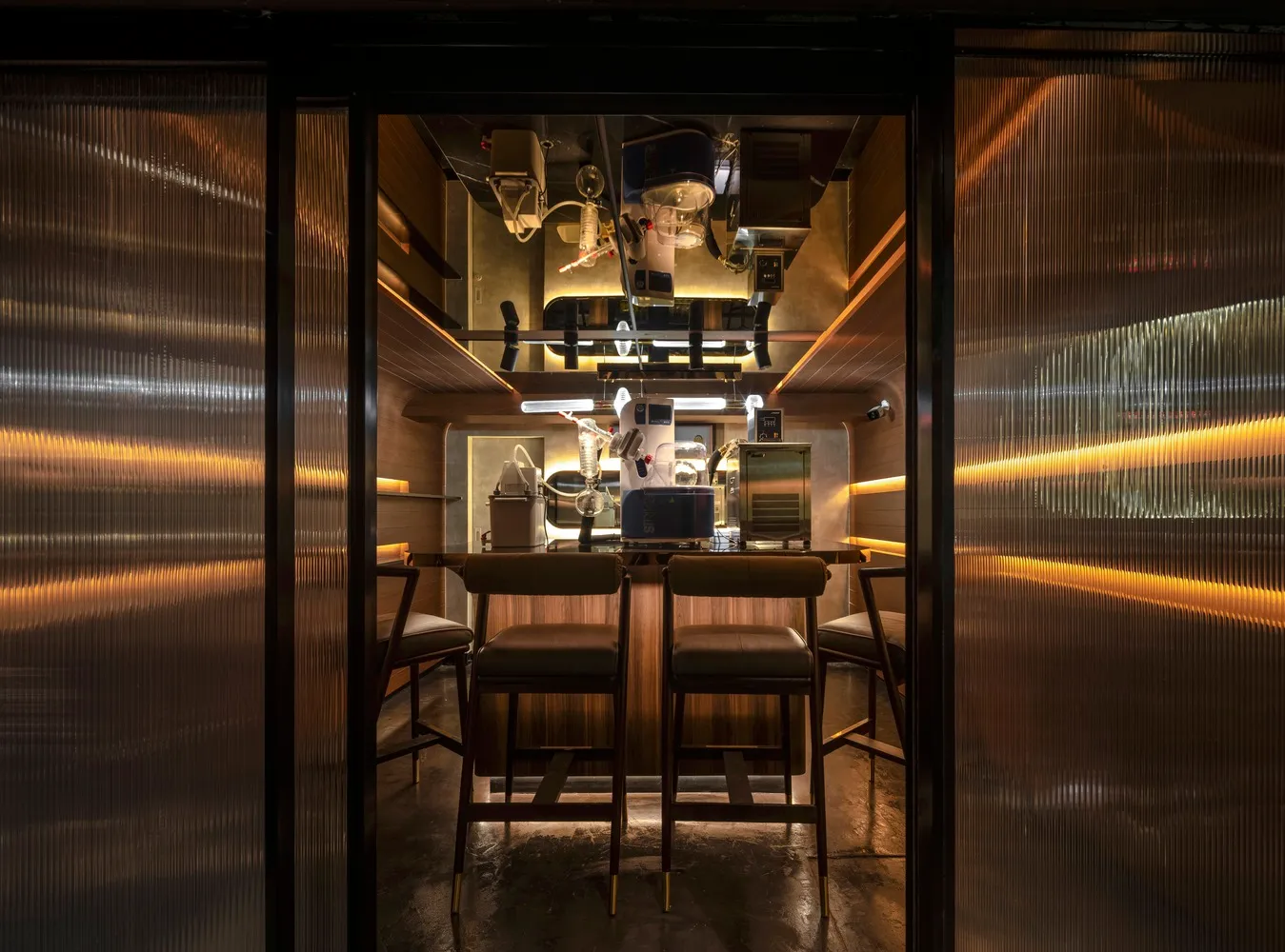 Industrial themed cafe bar interior with metal, wood, and glass materials.