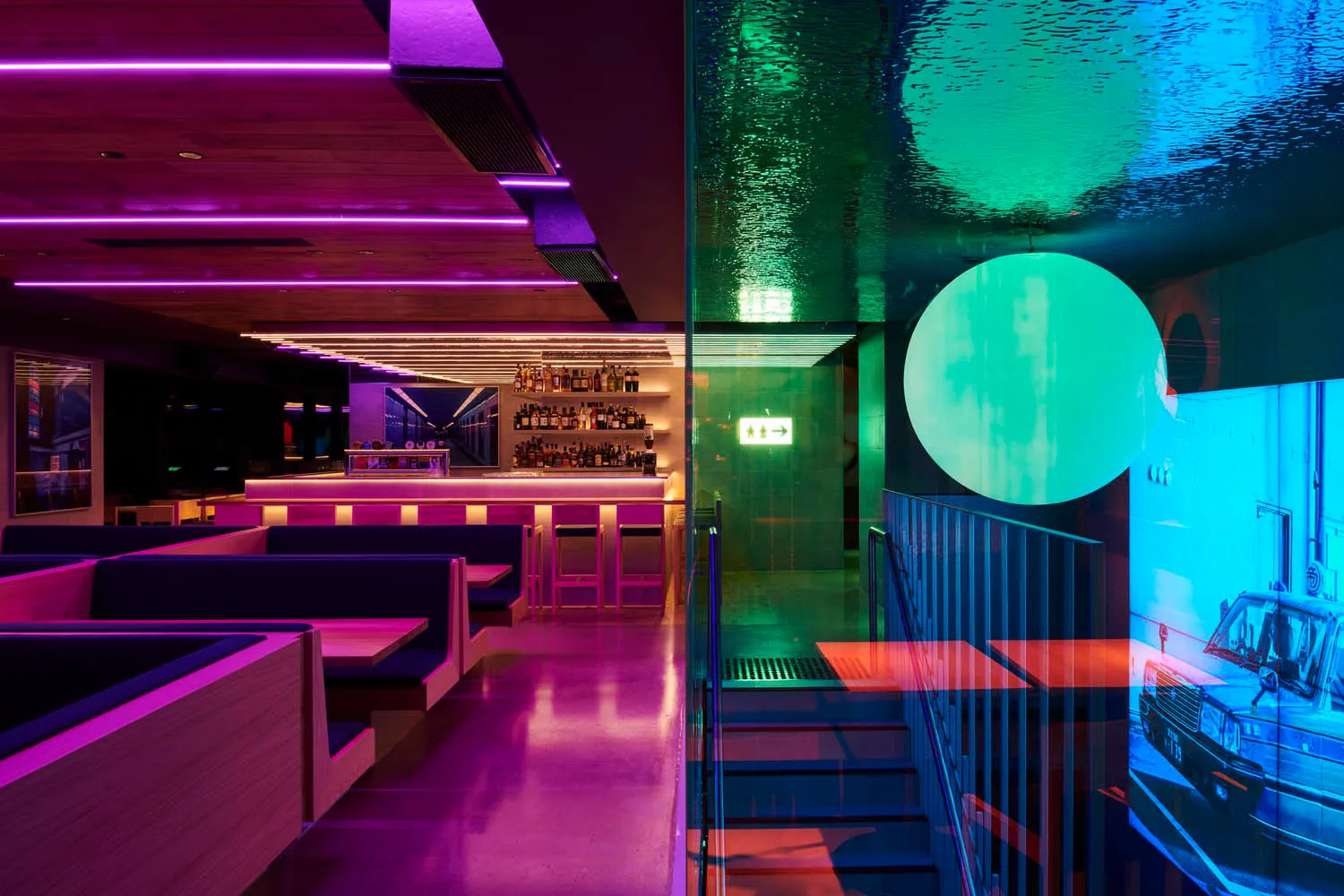 A modern restaurant bar with vibrant lighting and sleek design elements.