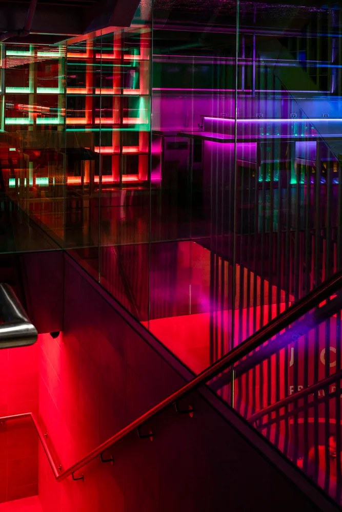 Modern nightclub interior with glass and metal features.