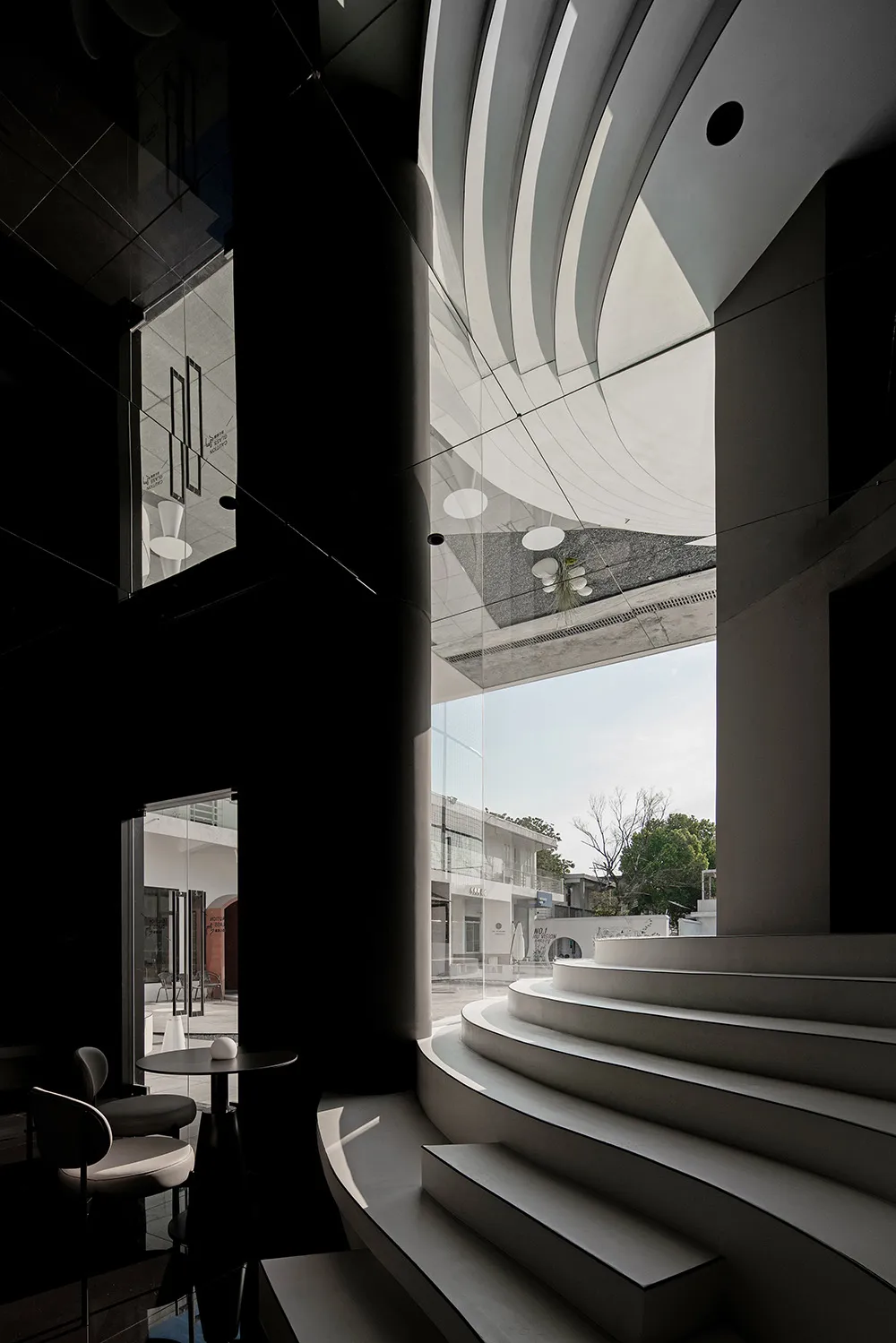 A modern interior space featuring concrete materials and steps.