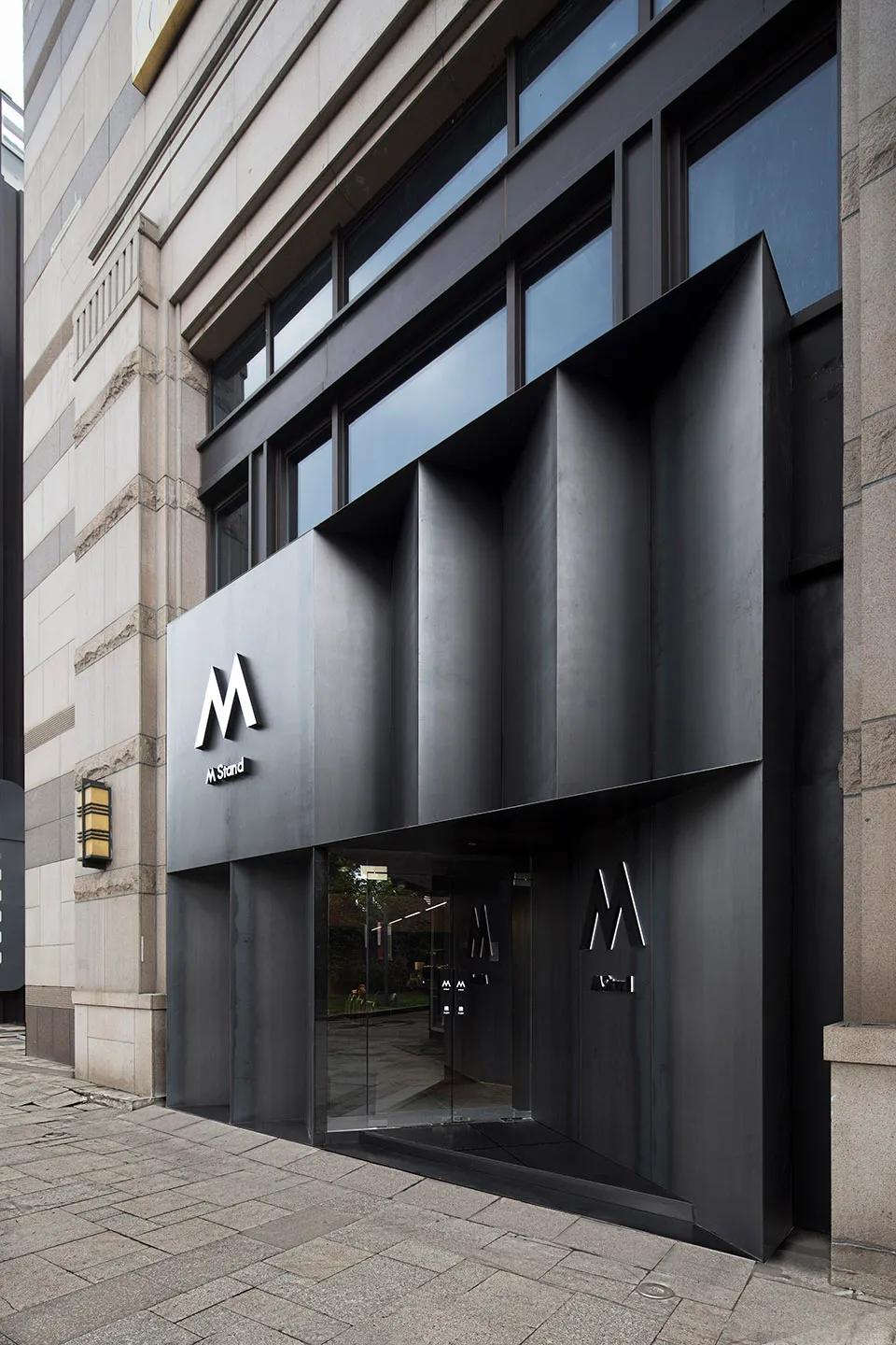 Modern exterior of a commercial building with a metal and glass facade.