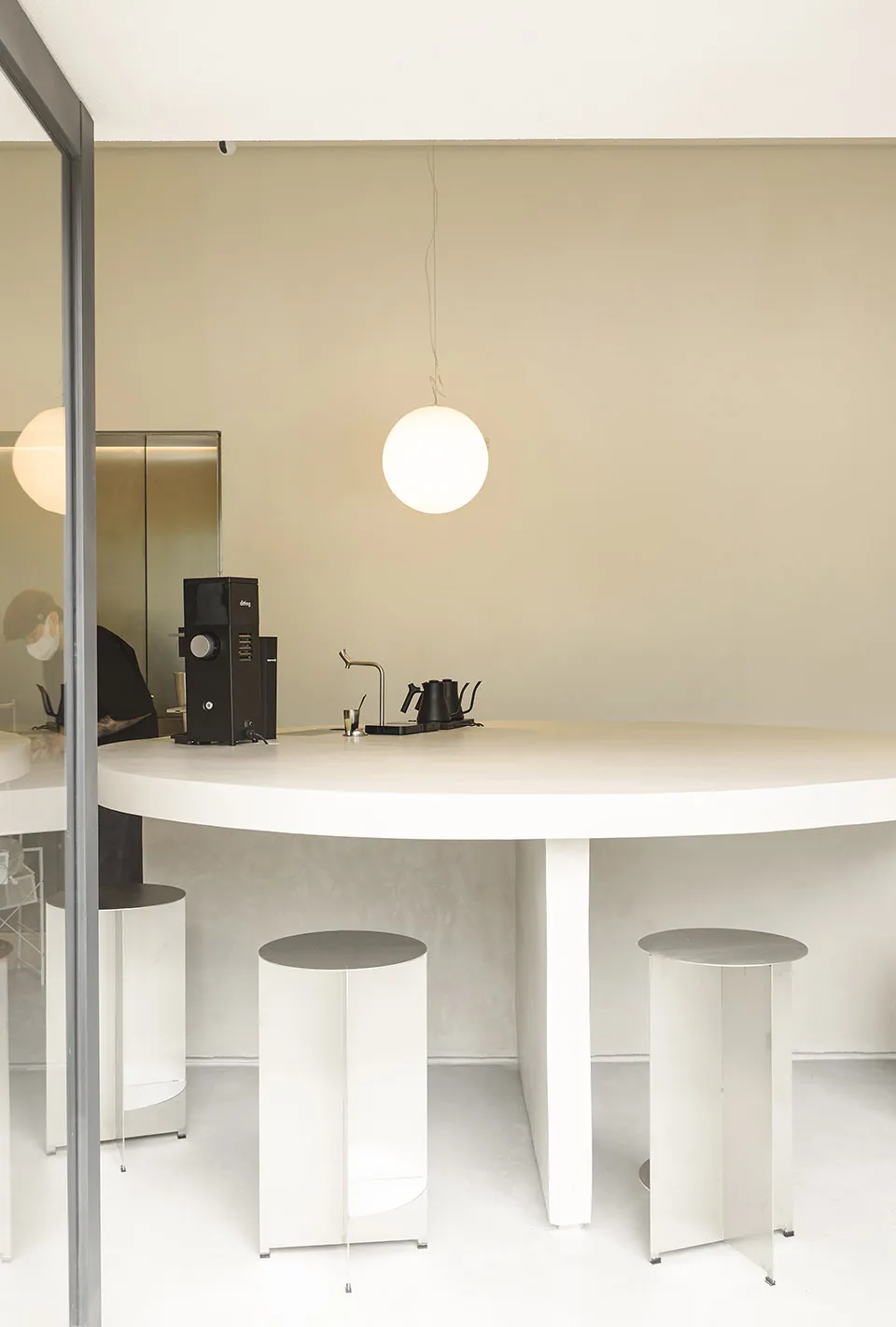 White concrete kitchen with minimalist design and functional features.