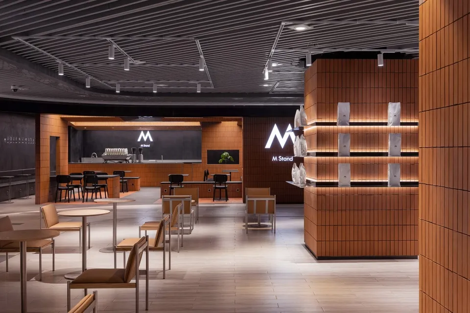 Contemporary coffee shop featuring modern design elements of wood and concrete.