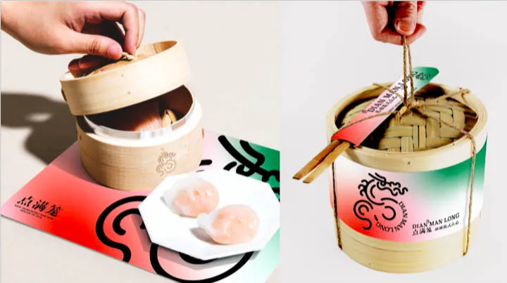 A hand holding a bamboo steamer basket with a tag labeled 'DIAN·MAN LONG' and chopsticks beside it, next to two dumplings on