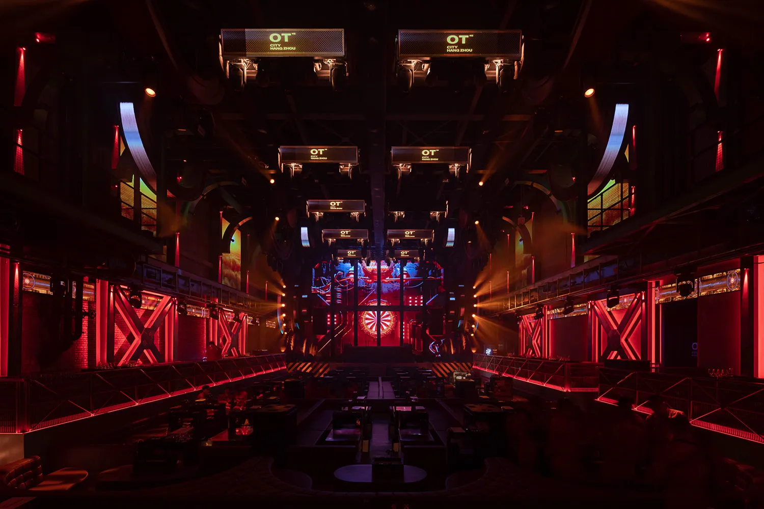 A large, modern nightclub with vibrant LED lighting and a central stage area.