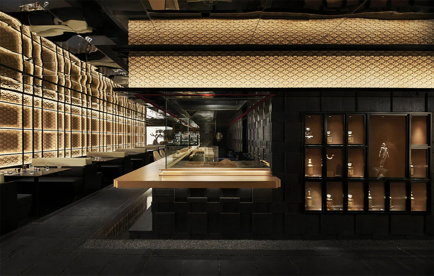 A minimalist restaurant interior with concrete and wooden elements.