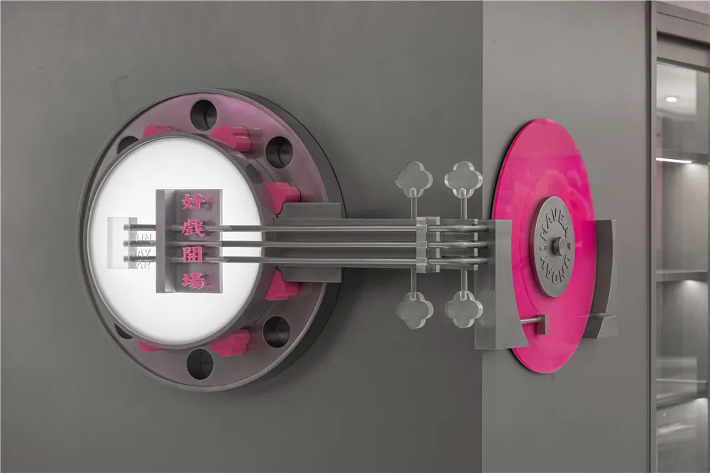 A modern, metallic doorway with pink and grey accents.