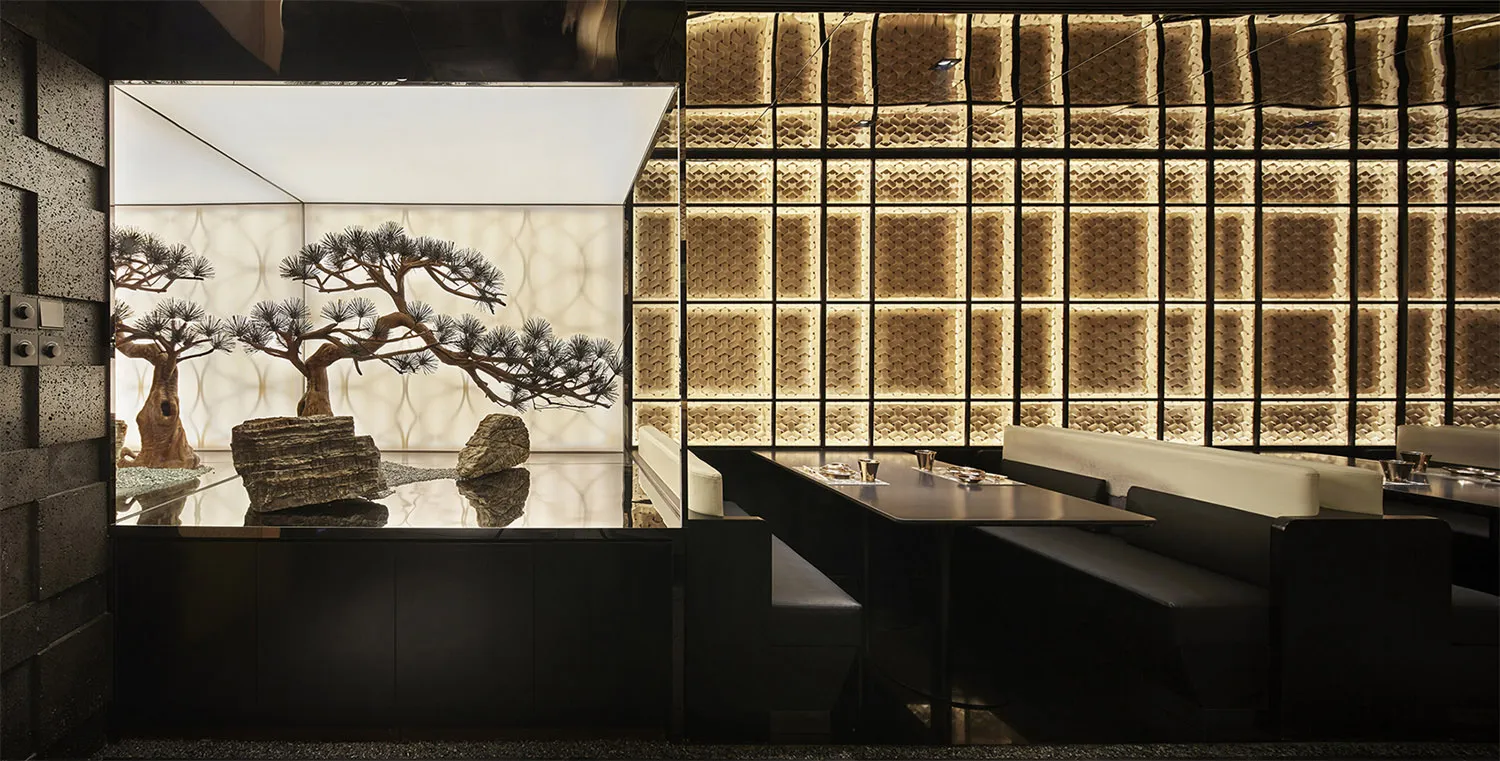 Modern restaurant interior with metallic wall panels and seating areas