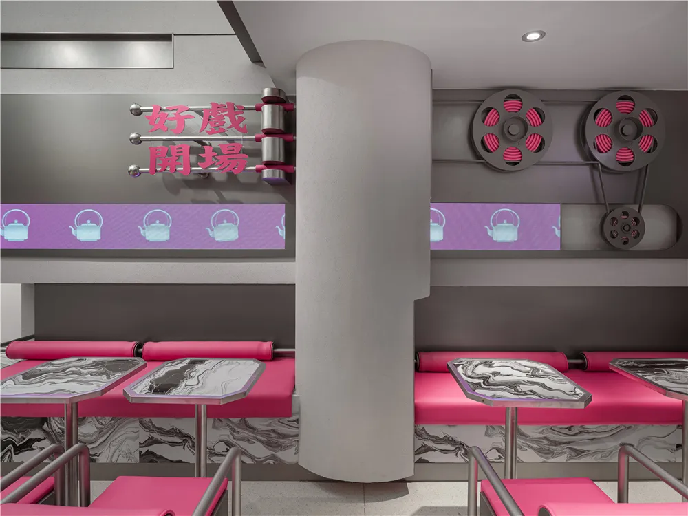 A modern restaurant interior featuring plastic tables, marble counters, tea pots, and posters.