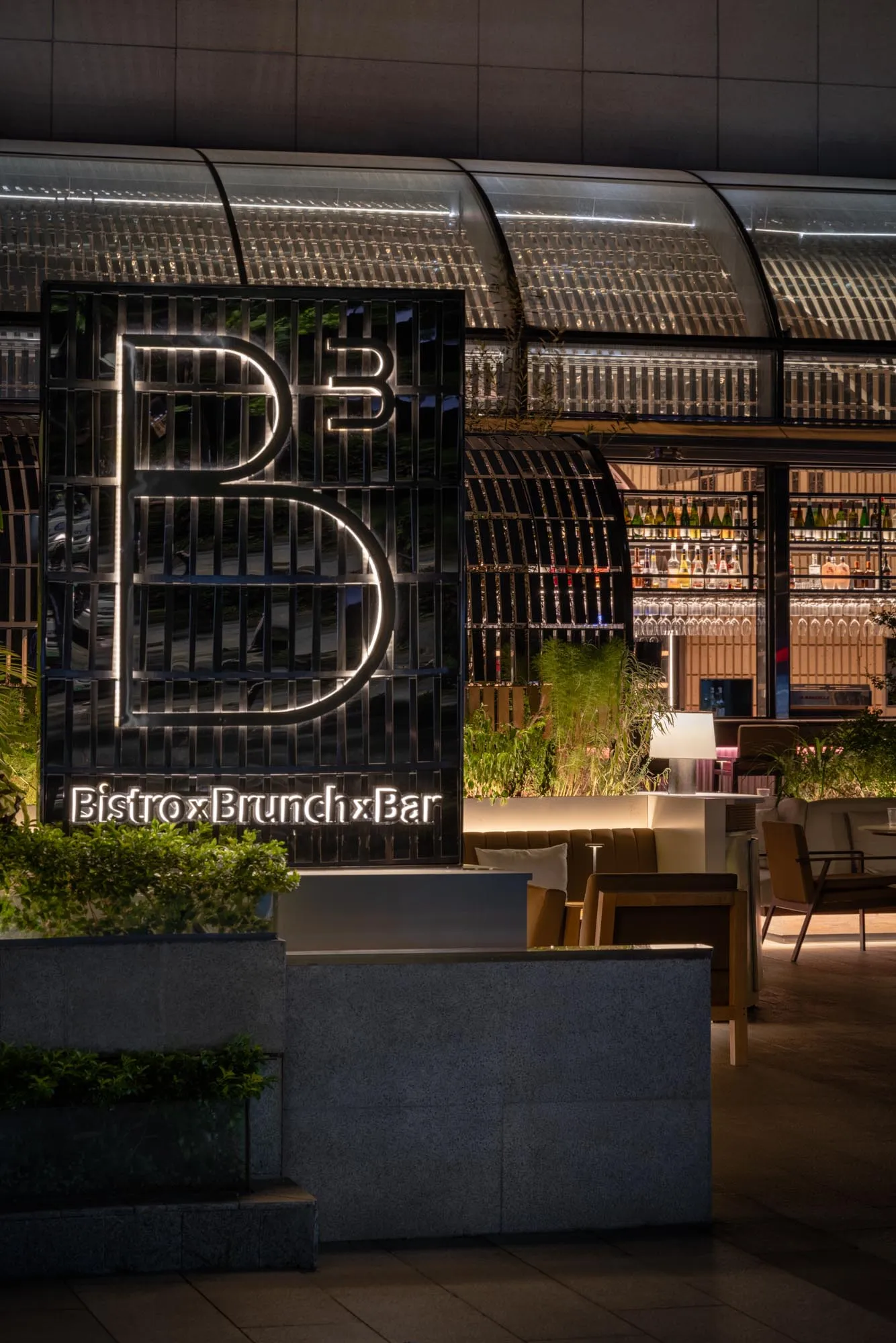 A modern restaurant exterior featuring metallic elements and a contemporary design.