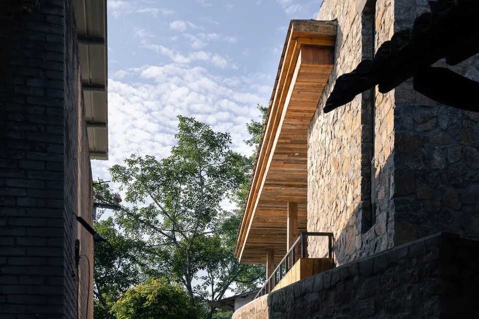 An exterior of a building with stucco and wooden features.
