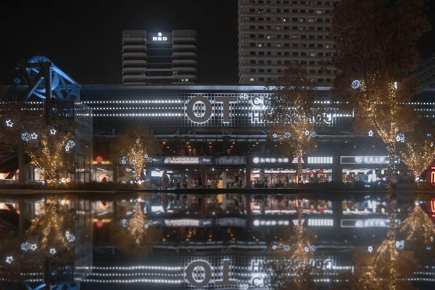 An illuminated cityscape at night with modern architectural features.