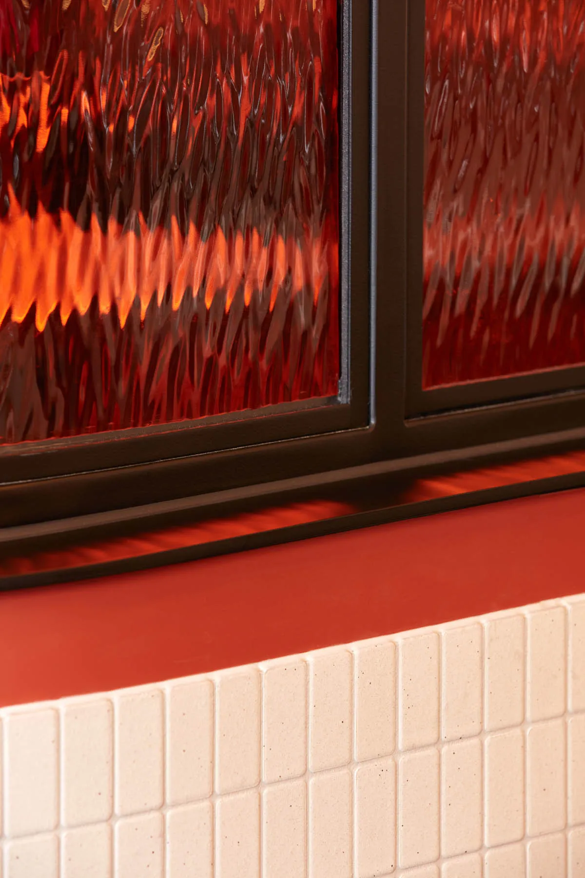 A close-up view of a window displaying reflections and the play of light and shadows.