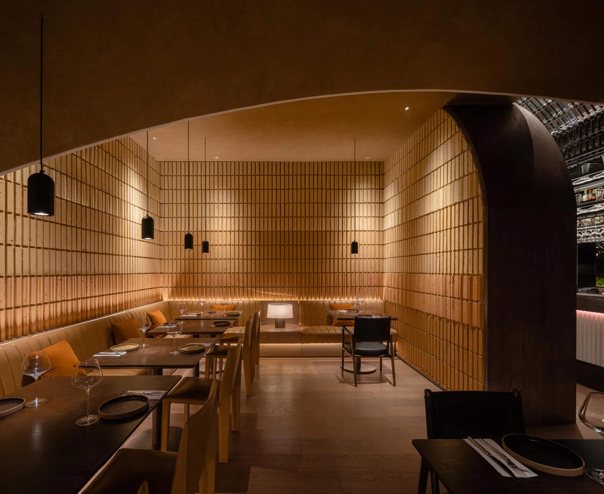 Modern wooden restaurant interior with tables, chairs, and pendant lights.