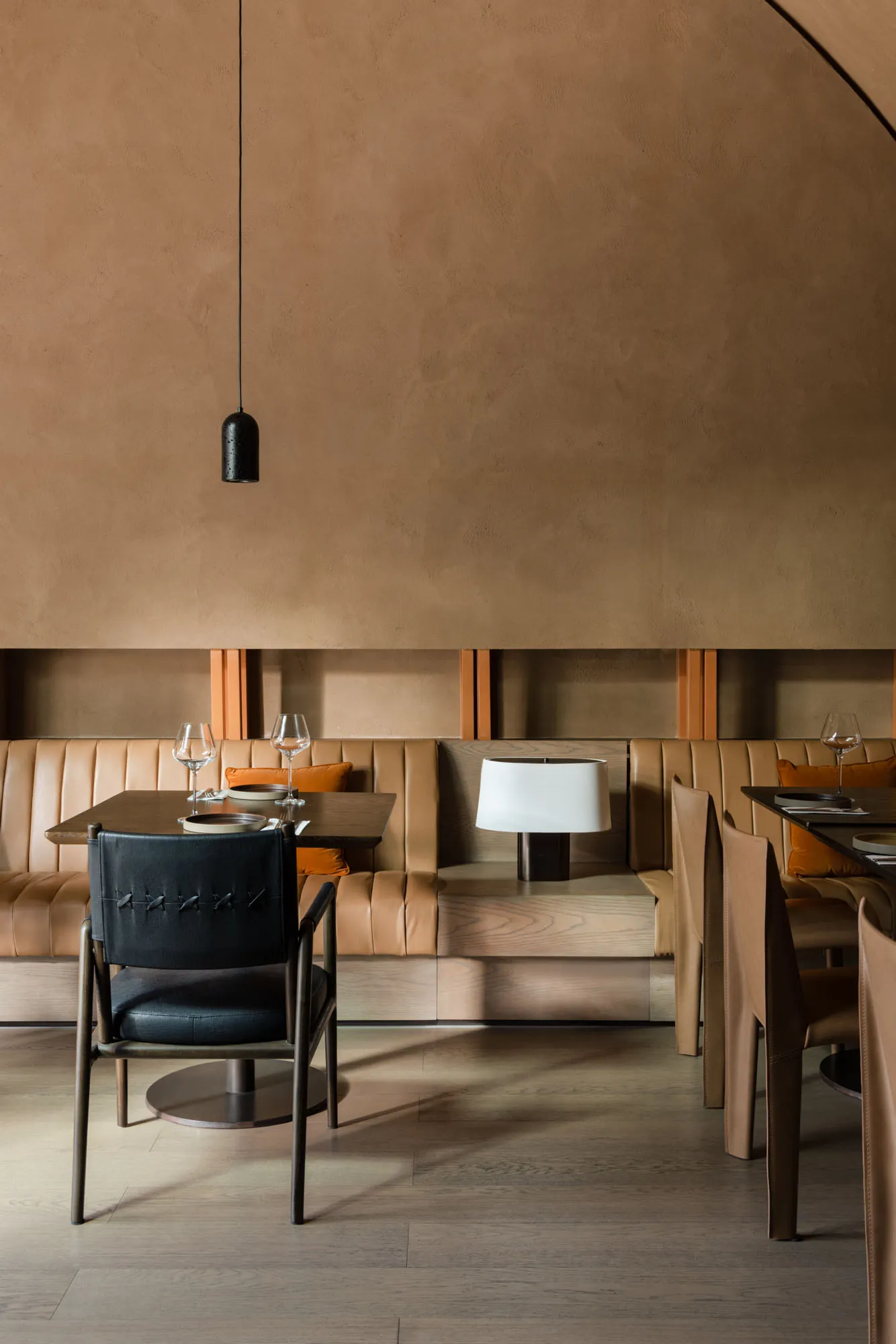 Modern restaurant table with a wooden table and leather chairs.