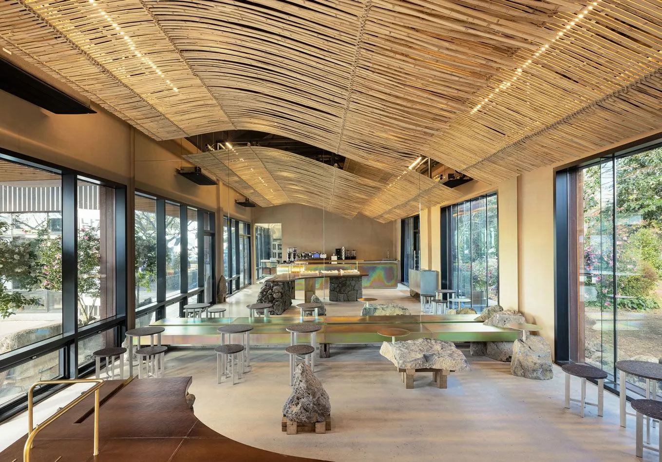 Interior view of a modern cafe featuring timber elements and a spacious, airy atmosphere.