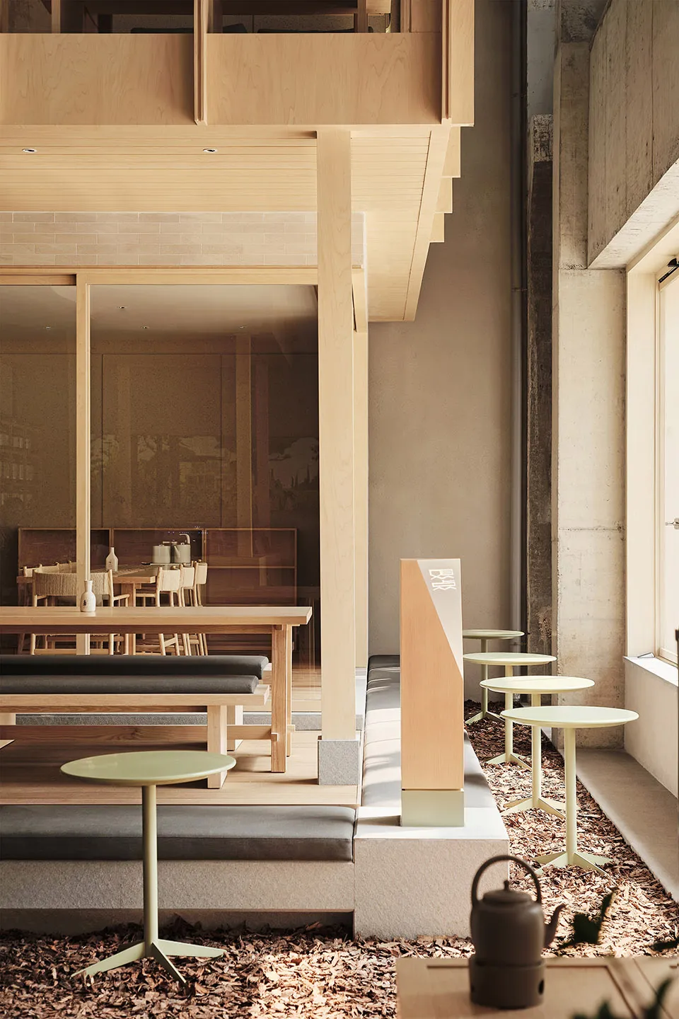 Modern cafe interior with wooden tables and concrete accents.