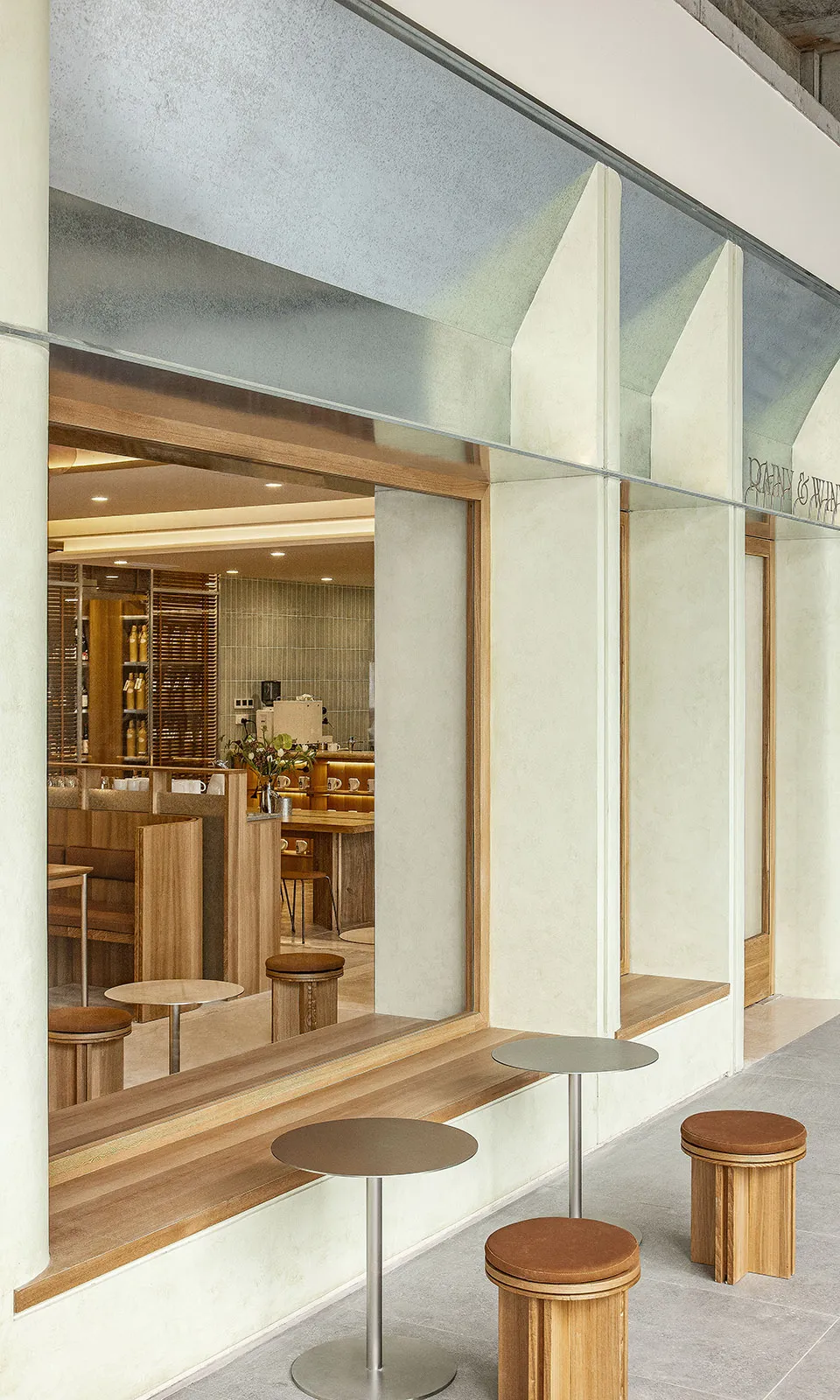 Modern coffee shop interior with wooden furniture and large glass windows