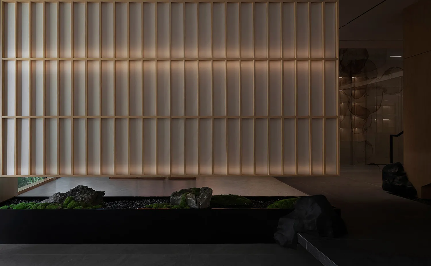 A minimalistic interior space featuring wooden walls and stone accents