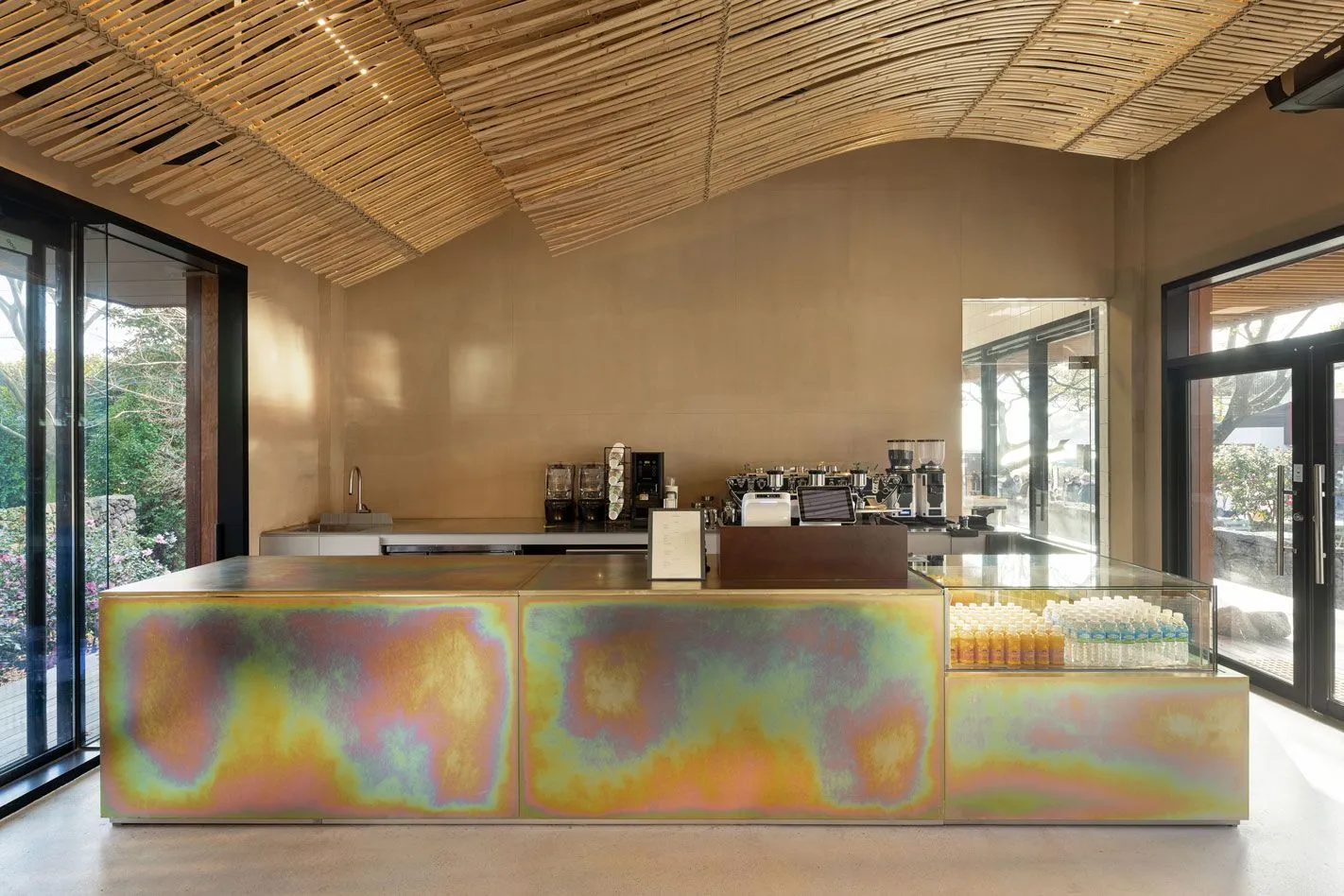 Modern coffee shop counter with a multicolored metallic design.