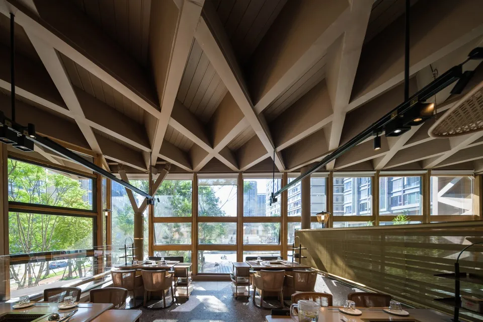 Modern restaurant interior featuring concrete and glass elements.