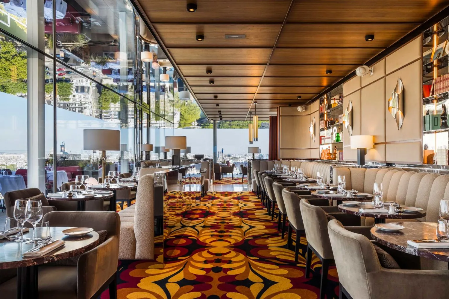 Modern restaurant interior featuring elegant furniture, marble accents, and warm lighting