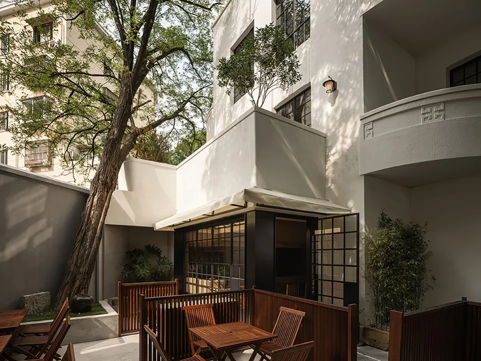 Modern residential patio with wooden furniture and plants