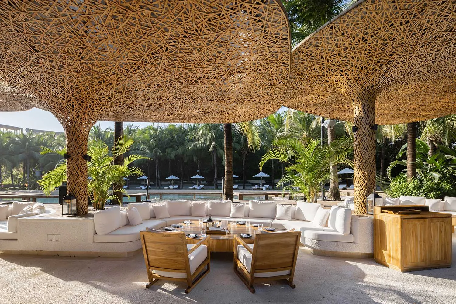 Lounge area with white cushions and wooden lattice structure