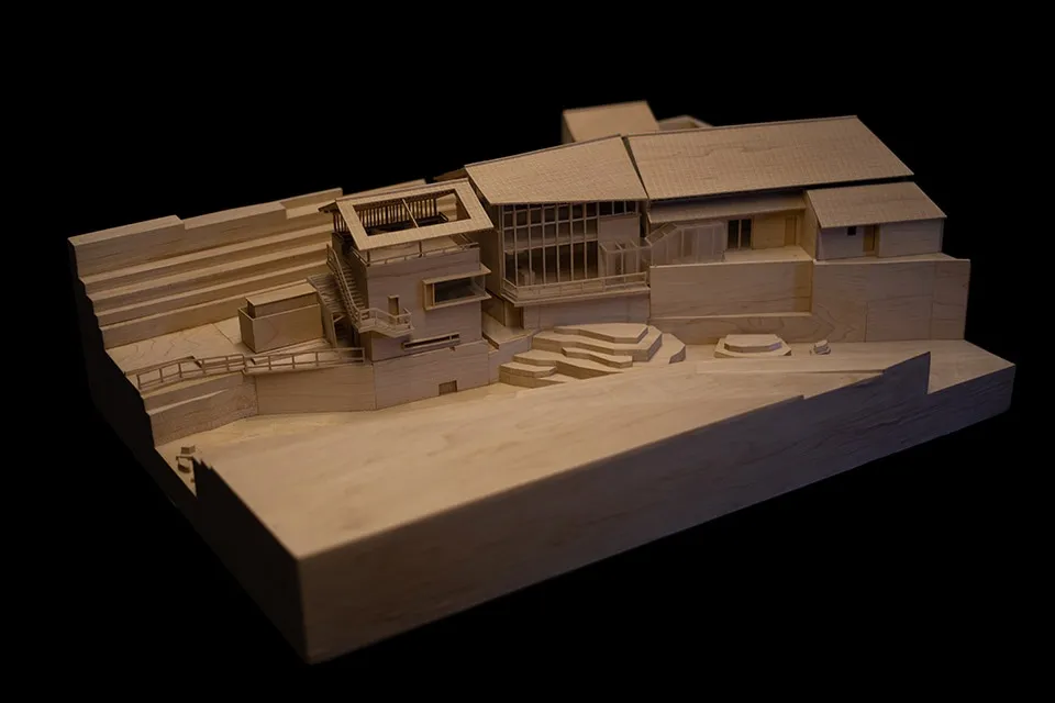 A wooden architectural model of a residential building with contemporary design features.
