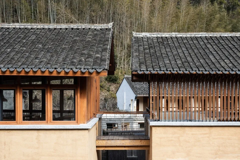 Modern residential building with wooden roof tiles and a balcony.