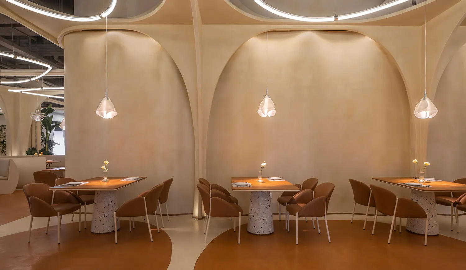 Modern restaurant dining area with terrazzo tables and chairs, minimalistic design style, curved archways, and minimal lighti