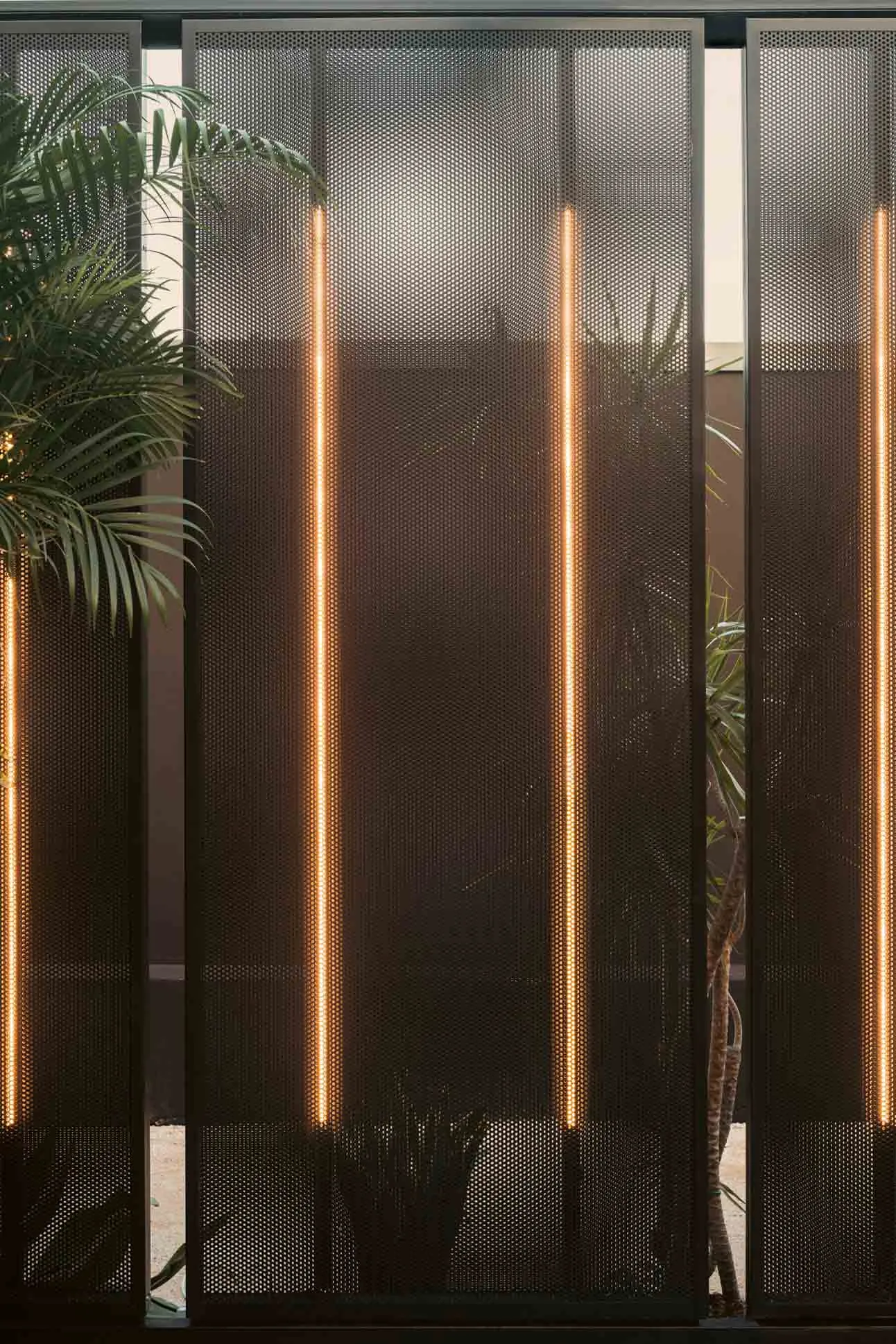 Metal perforated panel with integrated lighting as an indoor partition