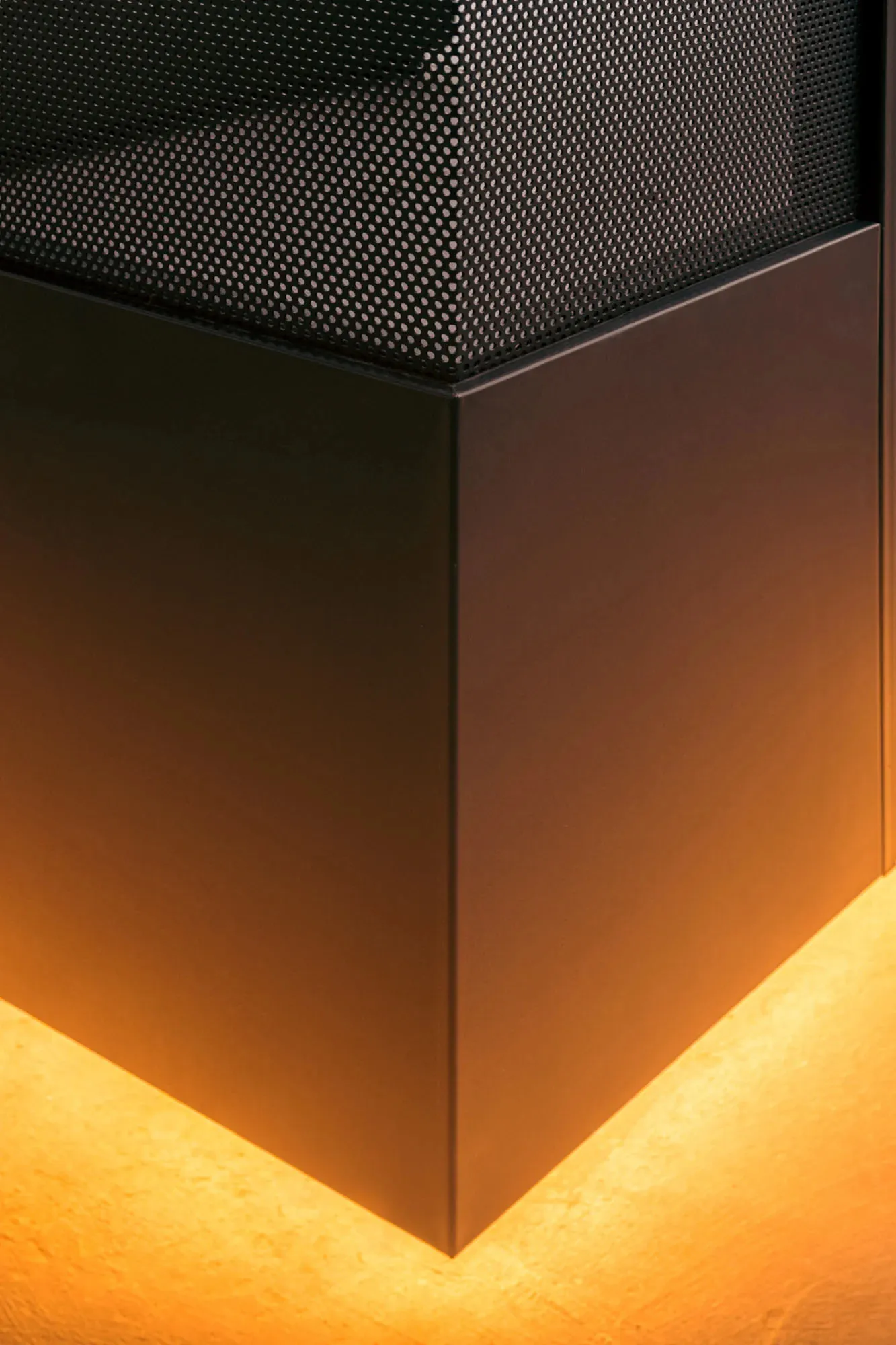 Modern interior design featuring metallic elements with orange lighting